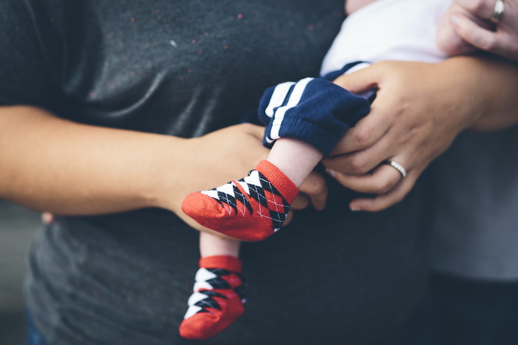 Baby Feet in Argyle Socks Being Held by Mom