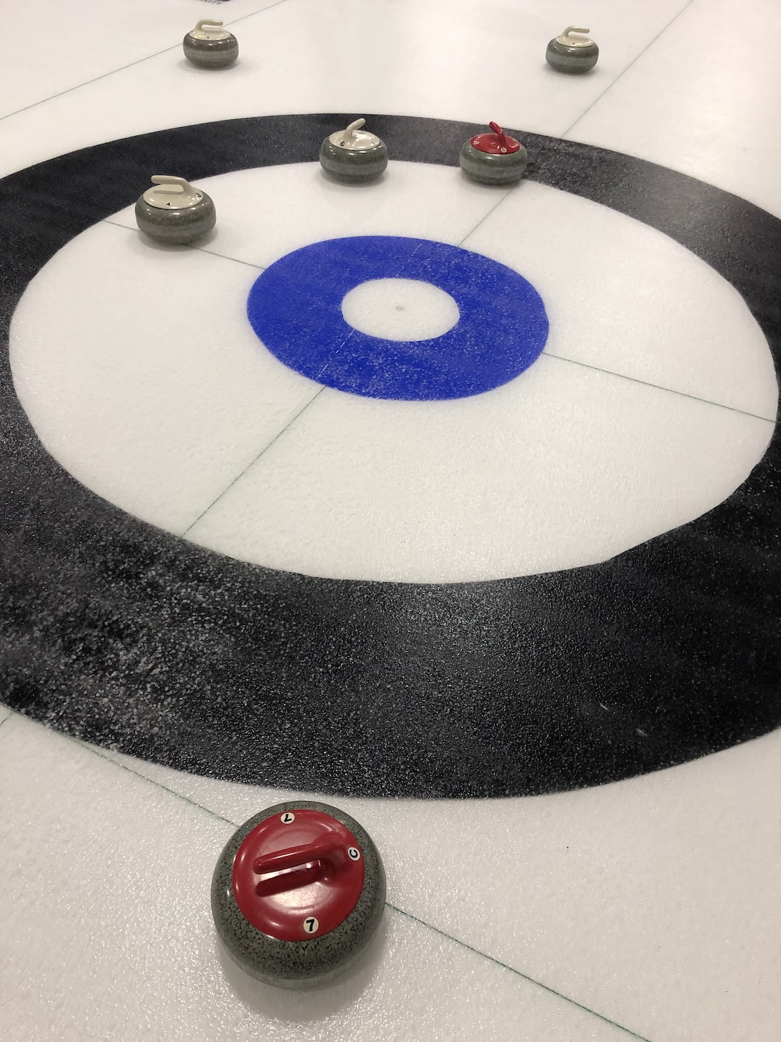 Curling Rocks in House on Rink