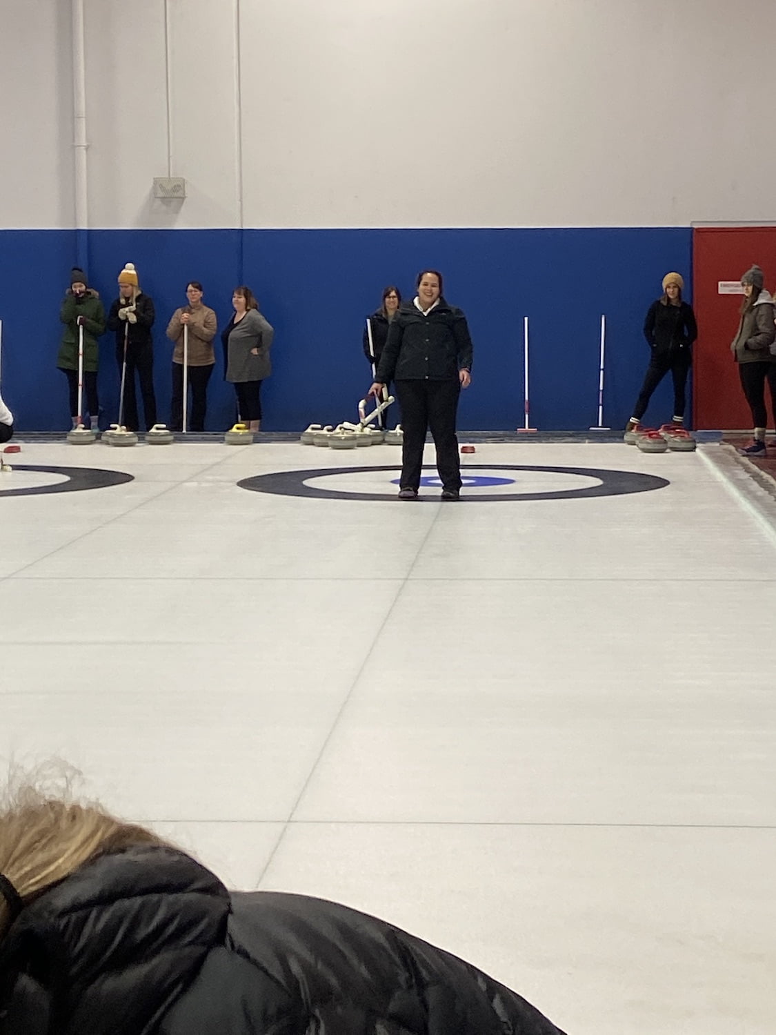 Woman Smiling After Throwing Curling Rock
